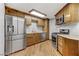 Kitchen with stainless steel appliances, wood cabinets, and granite countertops at 4075 E Oquendo Rd, Las Vegas, NV 89120