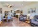 Open-concept living space with dining area, and kitchen, featuring modern furnishings and wood-look floors at 4075 E Oquendo Rd, Las Vegas, NV 89120