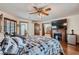 Main bedroom with wood floors, a fireplace, and views to an attached bathroom at 4075 E Oquendo Rd, Las Vegas, NV 89120
