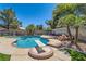 Inviting backyard pool features mature landscaping, diving board and room for entertaining at 4075 E Oquendo Rd, Las Vegas, NV 89120