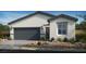 Charming single-story home featuring a grey garage door, neutral paint, desert landscaping, and modern architectural details at 4160 E Brusca Way, Pahrump, NV 89061