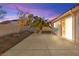 Backyard with patio, rock features, mature landscaping and exterior house view at 433 Old Palms Dr, Las Vegas, NV 89123