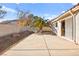 Backyard with patio, rock features, mature landscaping and exterior house view at 433 Old Palms Dr, Las Vegas, NV 89123
