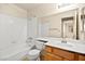 Bathroom featuring a white tiled shower/tub, oak cabinets and a large mirror at 433 Old Palms Dr, Las Vegas, NV 89123