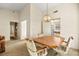 Charming dining area with a classic chandelier and adjacent doorway to the kitchen at 433 Old Palms Dr, Las Vegas, NV 89123