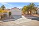 Single-Gathering home showcasing desert landscaping, a two-car garage, and a tile roof at 433 Old Palms Dr, Las Vegas, NV 89123