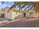 Charming single-story home with a two-car garage, desert landscaping, and mature palm trees at 433 Old Palms Dr, Las Vegas, NV 89123
