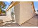 Exterior home with a concrete walkway, stucco wall, and desert landscaping at 433 Old Palms Dr, Las Vegas, NV 89123
