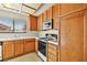 Well-lit kitchen with white countertops, wood cabinets and stainless steel appliances at 433 Old Palms Dr, Las Vegas, NV 89123