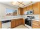 Well-lit kitchen with wood cabinets, white countertops, and a window with blinds at 433 Old Palms Dr, Las Vegas, NV 89123