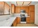 Functional kitchen featuring a range, microwave, and window over the sink at 433 Old Palms Dr, Las Vegas, NV 89123
