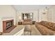 Comfortable living room with a brick fireplace, carpet, and a large window at 433 Old Palms Dr, Las Vegas, NV 89123