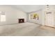 Cozy living room featuring a brick fireplace, large window, and neutral walls at 433 Old Palms Dr, Las Vegas, NV 89123
