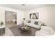 Stylishly staged living room with white sofa, modern art, and dual coffee tables at 433 Old Palms Dr, Las Vegas, NV 89123