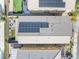 Aerial view of roof and backyard with solar panels, patio, fire pit, and synthetic grass at 4519 Stardusk Falls Ave, North Las Vegas, NV 89084