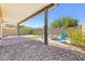 Charming backyard with fire pit area, artificial turf, and a covered patio for relaxing outdoors at 4519 Stardusk Falls Ave, North Las Vegas, NV 89084