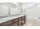 Bathroom boasts double sinks, granite countertops, and a separate toilet area, combining style and functionality at 4519 Stardusk Falls Ave, North Las Vegas, NV 89084