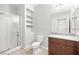 Clean bathroom featuring a glass-enclosed shower, modern toilet, and granite countertop at 4519 Stardusk Falls Ave, North Las Vegas, NV 89084