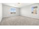 Bright, carpeted bedroom with large windows, creating a comfortable and inviting space with plenty of natural light at 4519 Stardusk Falls Ave, North Las Vegas, NV 89084