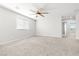 Spacious bedroom featuring plush carpeting, ceiling fan and a view to the exterior at 4519 Stardusk Falls Ave, North Las Vegas, NV 89084