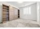 Cozy bedroom featuring carpet floors, a custom Murphy bed, and built in shelving at 4519 Stardusk Falls Ave, North Las Vegas, NV 89084