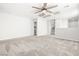 Large bonus room featuring neutral carpet, ceiling fan, and freshly painted walls at 4519 Stardusk Falls Ave, North Las Vegas, NV 89084