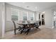 Charming dining room with a modern wooden table, stylish chairs, and large windows with shutters at 4519 Stardusk Falls Ave, North Las Vegas, NV 89084