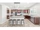 Modern kitchen featuring dark cabinets, stainless steel appliances, granite counters, and a breakfast bar at 4519 Stardusk Falls Ave, North Las Vegas, NV 89084