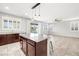 Bright, open kitchen with granite island, stainless steel appliances, and view to outdoor patio at 4519 Stardusk Falls Ave, North Las Vegas, NV 89084