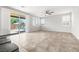 Bright living room with tile floors, neutral decor, and a sliding glass door leading to the backyard at 4519 Stardusk Falls Ave, North Las Vegas, NV 89084