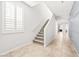 Bright staircase with carpeted steps and white trim, complemented by neutral-toned walls at 4519 Stardusk Falls Ave, North Las Vegas, NV 89084