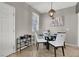 Dining room with a modern chandelier and seating for four at 50 Aura De Blanco St # 18204, Henderson, NV 89074