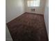 Carpeted bedroom with window and air conditioning unit at 5390 Swenson St # 27, Las Vegas, NV 89119