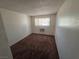 Carpeted bedroom with window and air conditioning unit at 5390 Swenson St # 27, Las Vegas, NV 89119