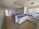 Open living room and kitchen space featuring tile floors and bright white walls at 5390 Swenson St # 27, Las Vegas, NV 89119