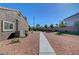 Low-maintenance gravel backyard offers ample space and potential for customization at 5725 N Durango Dr, Las Vegas, NV 89149