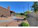 Spacious backyard with gravel, mature trees, and an inviting covered patio, ideal for outdoor living at 5725 N Durango Dr, Las Vegas, NV 89149