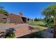 Expansive backyard features lush lawn, mature trees, and a charming covered patio at 5725 N Durango Dr, Las Vegas, NV 89149