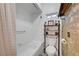 This bathroom features a shower over the tub and a decorative shelving unit over the toilet at 5725 N Durango Dr, Las Vegas, NV 89149
