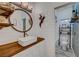 This bathroom features a wood vanity and a round mirror with shiplap on the wall at 5725 N Durango Dr, Las Vegas, NV 89149