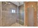 Modern bathroom with a glass-enclosed shower, tile walls, and built-in bench at 5725 N Durango Dr, Las Vegas, NV 89149