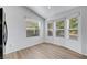 Bright breakfast nook features natural light through three large windows, and sleek wood-look floors at 5725 N Durango Dr, Las Vegas, NV 89149