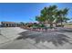The home boasts a spacious driveway, mature trees, a manicured lawn, and unique rock landscaping at 5725 N Durango Dr, Las Vegas, NV 89149