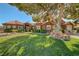 Beautiful home with lush green lawn, mature landscaping, and inviting curb appeal at 5725 N Durango Dr, Las Vegas, NV 89149