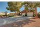 Charming home featuring a spacious driveway, two-car garage, beautiful yard, and mature trees at 5725 N Durango Dr, Las Vegas, NV 89149