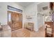 Inviting foyer features a wooden door, bench seating, and a decorative rug at 5725 N Durango Dr, Las Vegas, NV 89149