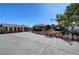 Low angle of a charming single-story home with mature trees, desert landscaping, and an American flag at 5725 N Durango Dr, Las Vegas, NV 89149