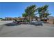 Charming single-story home with mature trees, desert landscaping, and an American flag in the front yard at 5725 N Durango Dr, Las Vegas, NV 89149