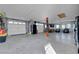 Spacious garage featuring epoxy floors, two car garage doors, storage, and a sitting area at 5725 N Durango Dr, Las Vegas, NV 89149