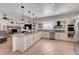Spacious kitchen with granite countertops, stainless steel appliances, and modern pendant lighting at 5725 N Durango Dr, Las Vegas, NV 89149